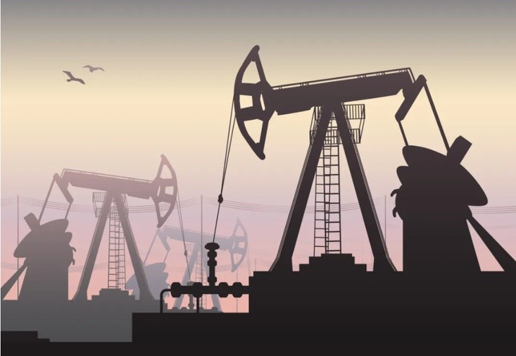 Oil pumpjack silhouettes at sunset
