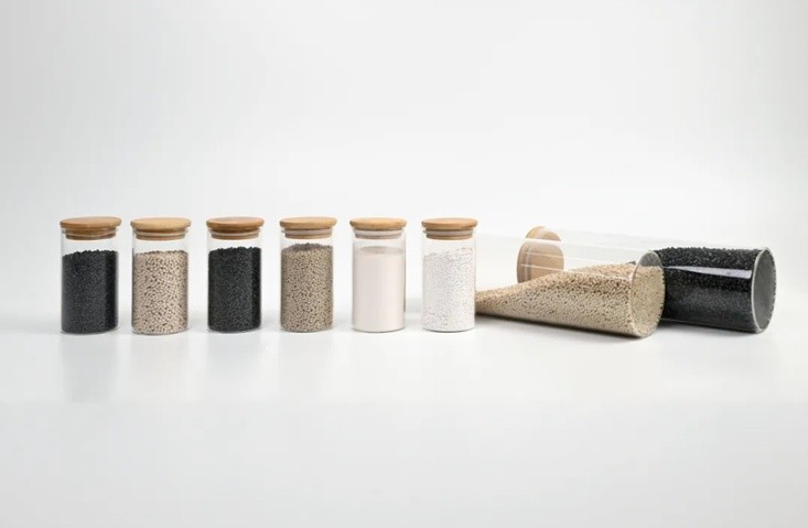 ZYPEEK resin pellets and powders displayed in glass containers